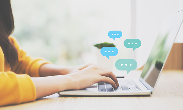 person typing on laptop with chat bubbles indicating communication and engagement in digital conversation about 5 key topics