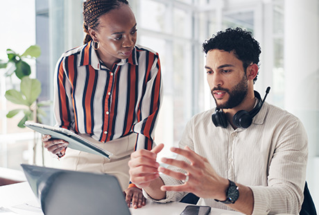 two colleagues discussing project details at desk professional environment technology focus 6 strategies for collaboration