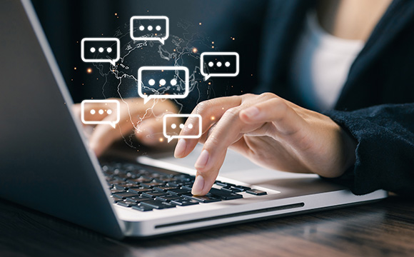 person typing on a laptop with chat bubbles and a global network representing online communication and engagement three interactions
