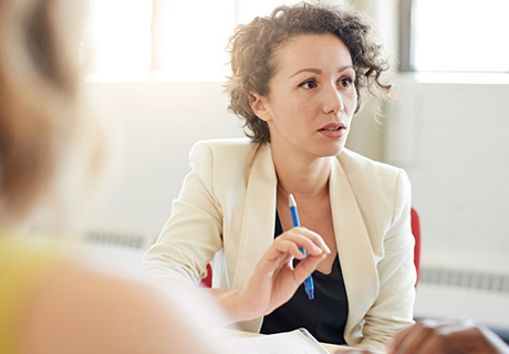 female professional engaged in conversation during meeting discussing six key points